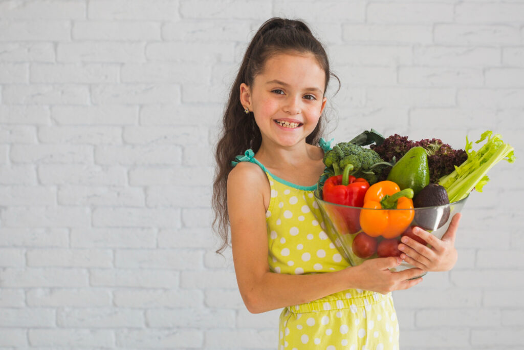 kid with a big bowl of vegetables 