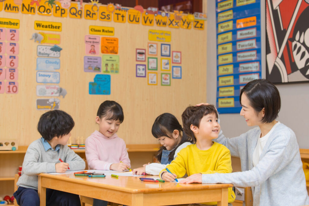 teacher sitting with students 
